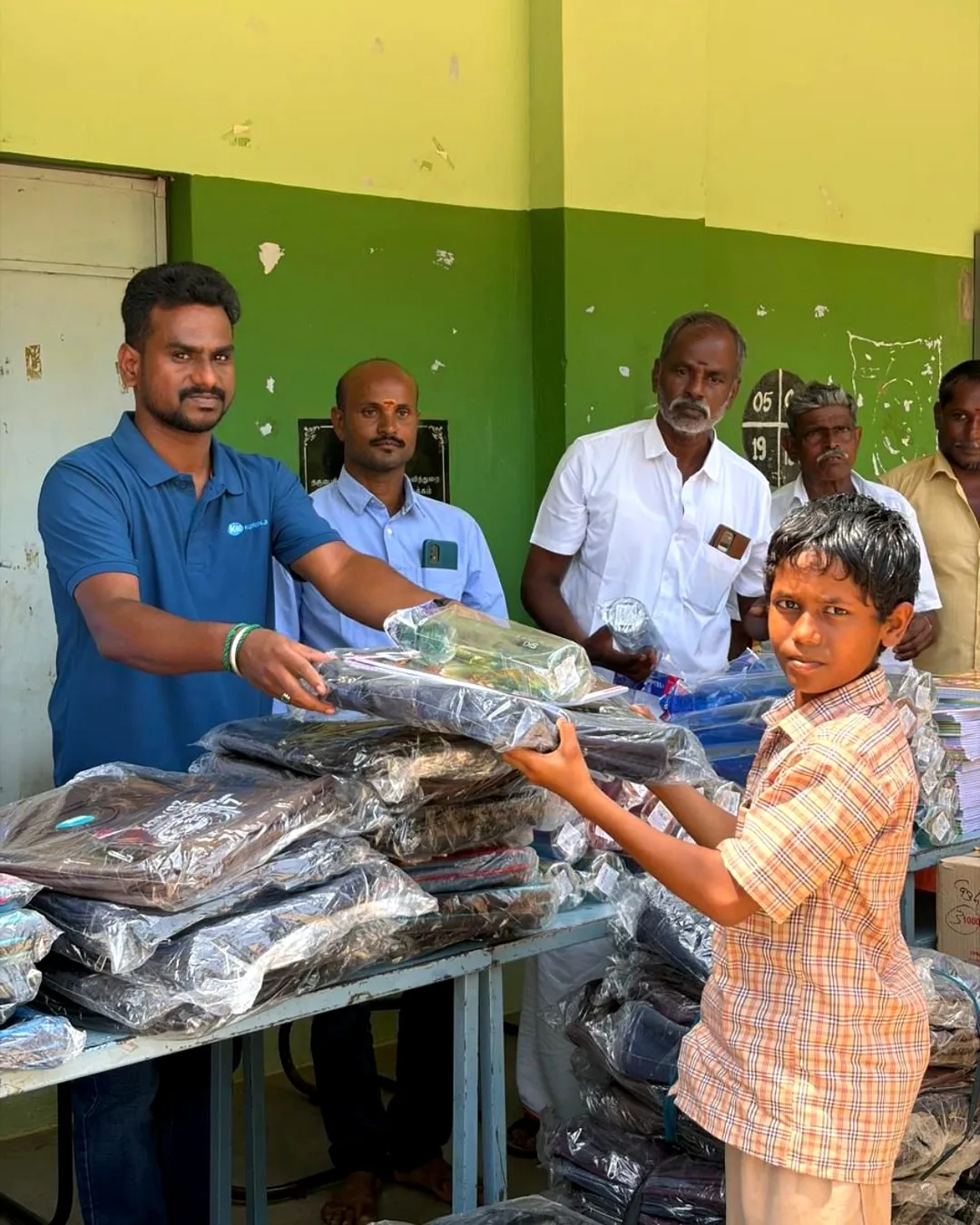 Students receiving school bags at Govt. High School, Kombukuttai