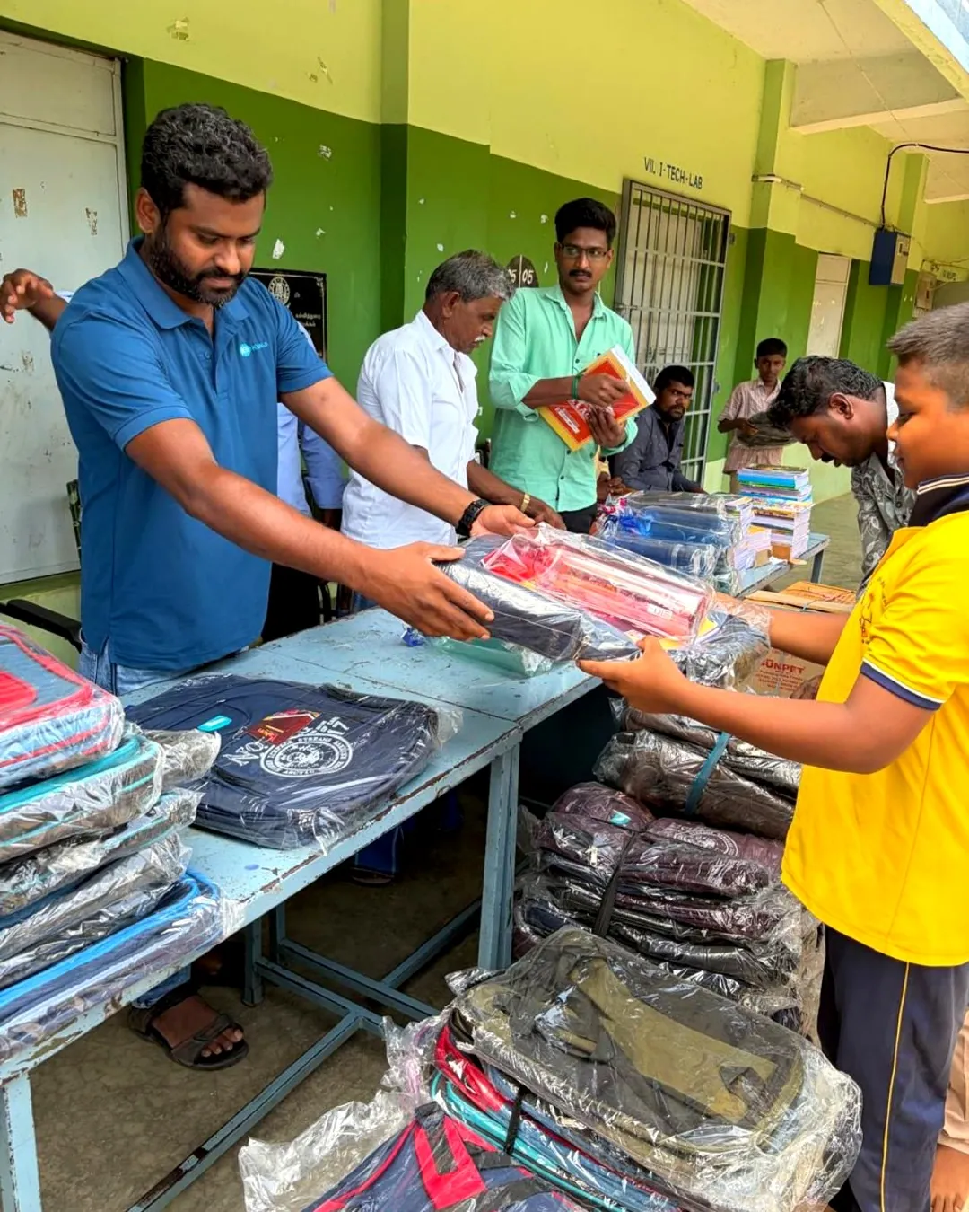 Students and teachers at the bag and notebook distribution, Kombukuttai